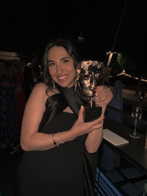 Haya Al Badarneh holding the BAFTA mask.