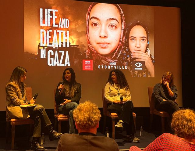 Panel discussion in front of the Life and Death in Gaza title card.